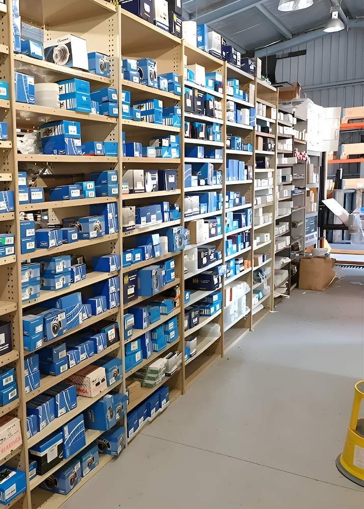 A Warehouse Filled With Lots of Blue Boxes on Shelves — Mid Coast Bearing Centre in Taree, NSW