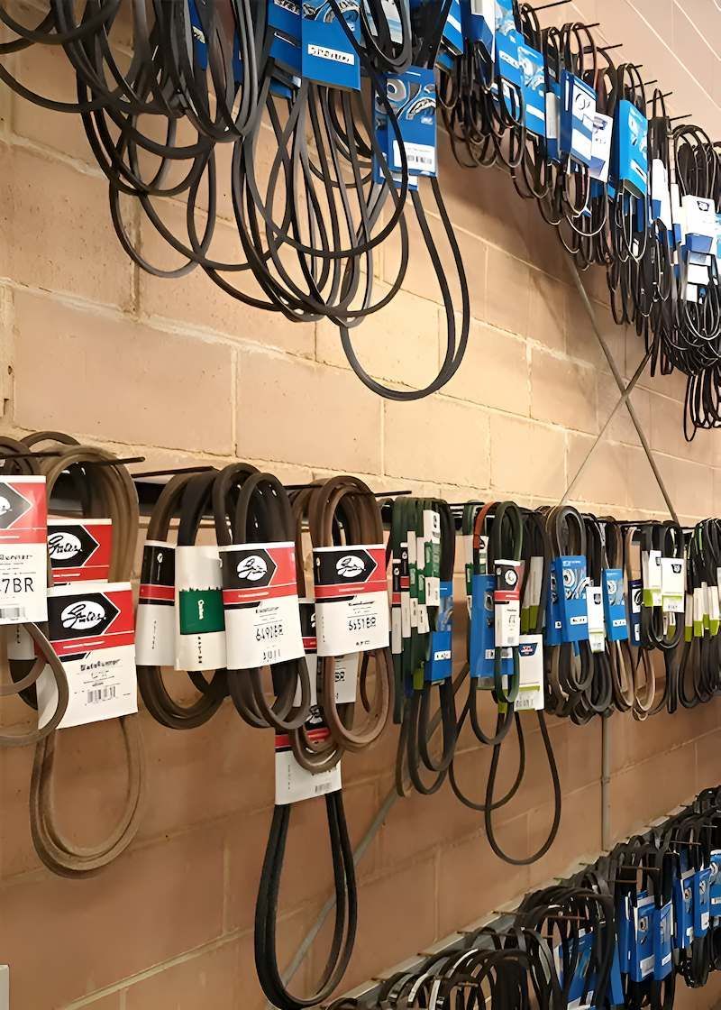 A Bunch of Belts Are Hanging on a Wall in a Store — Mid Coast Bearing Centre in Taree, NSW
