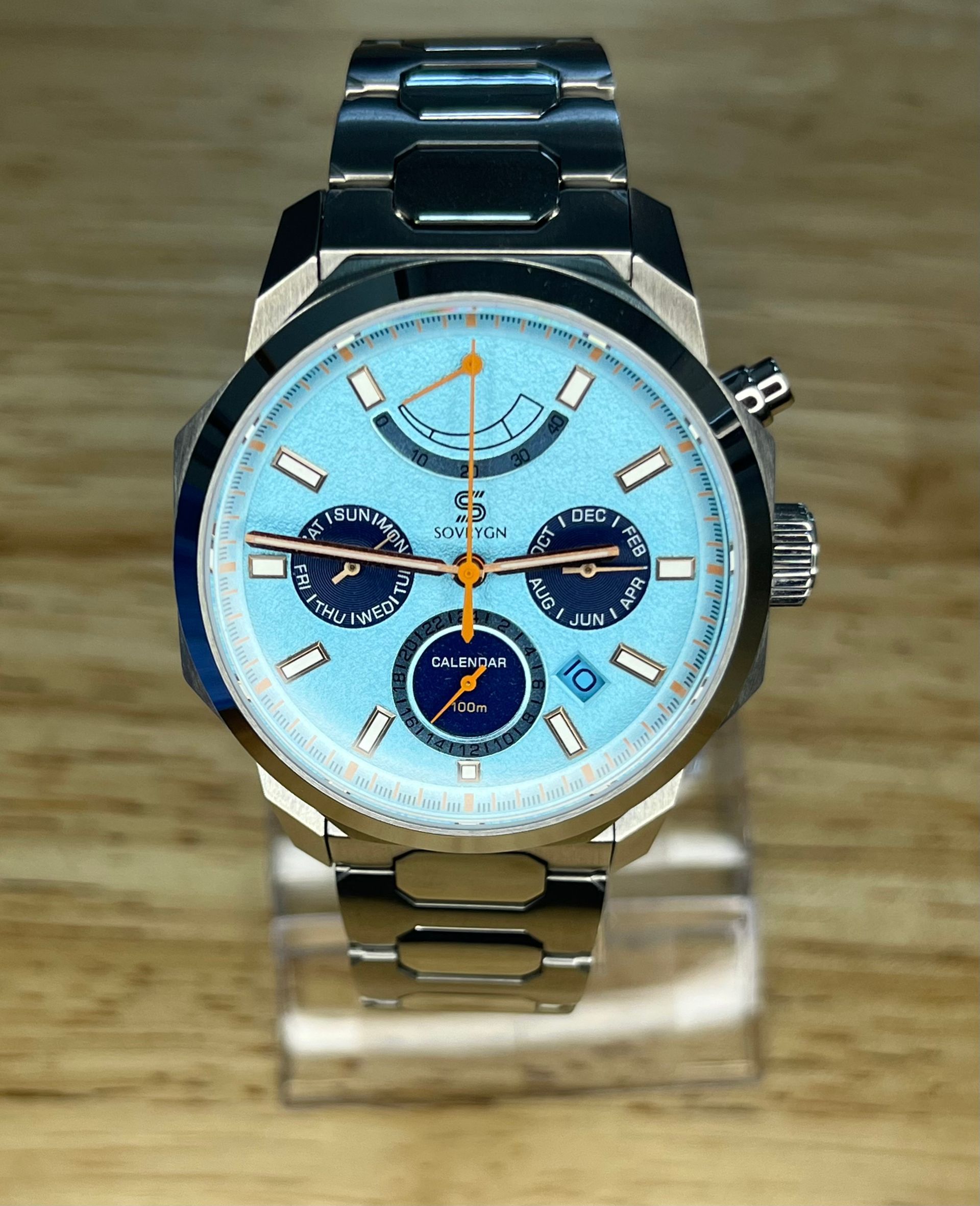 Silver watch with light blue face and silver band.