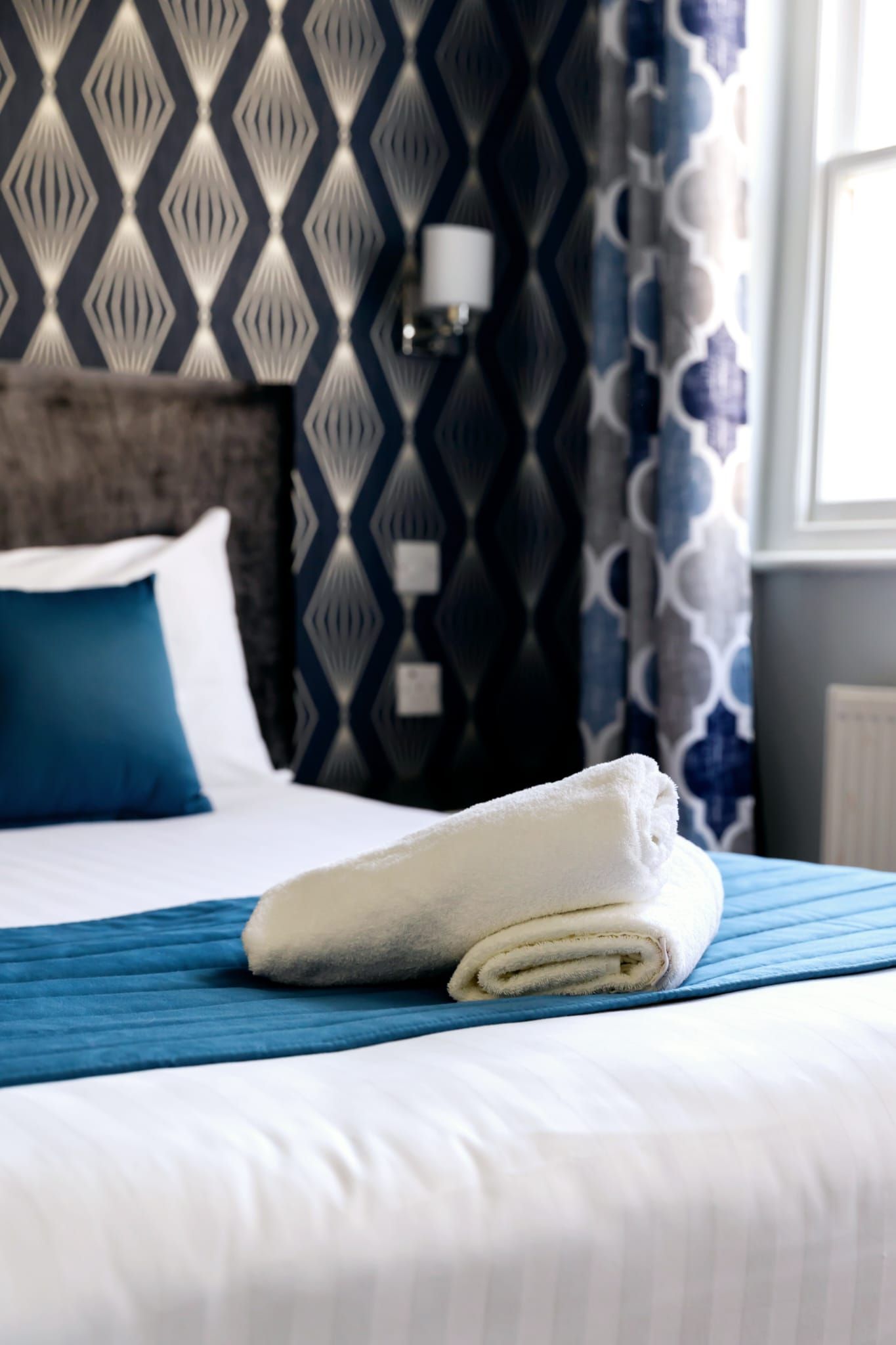 A hotel room with a bed and a towel on it