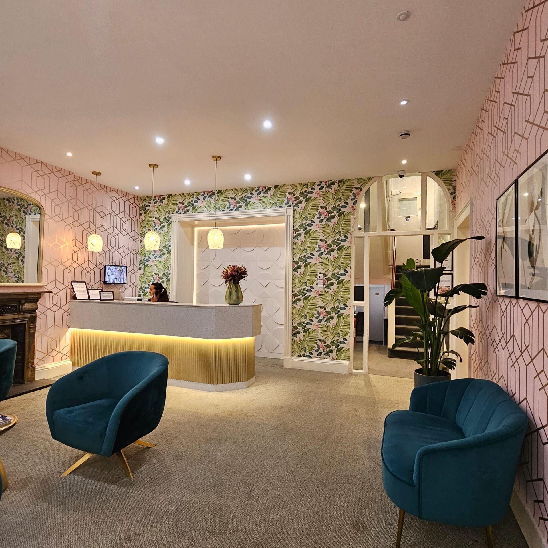 A room with a reception desk and chairs in it