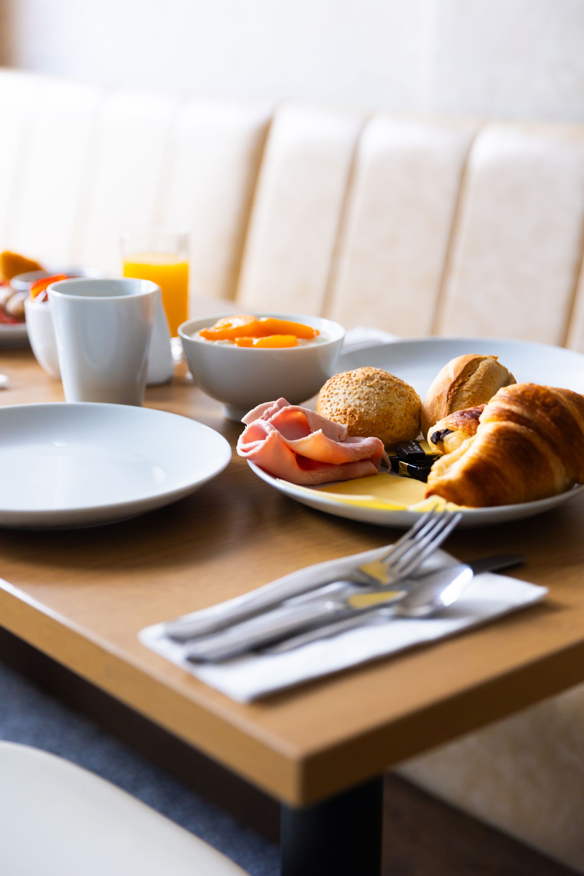 A table topped with plates of food and utensils.