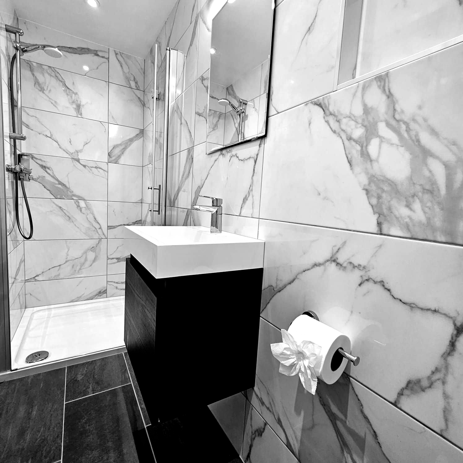 A bathroom with marble tiles and a sink
