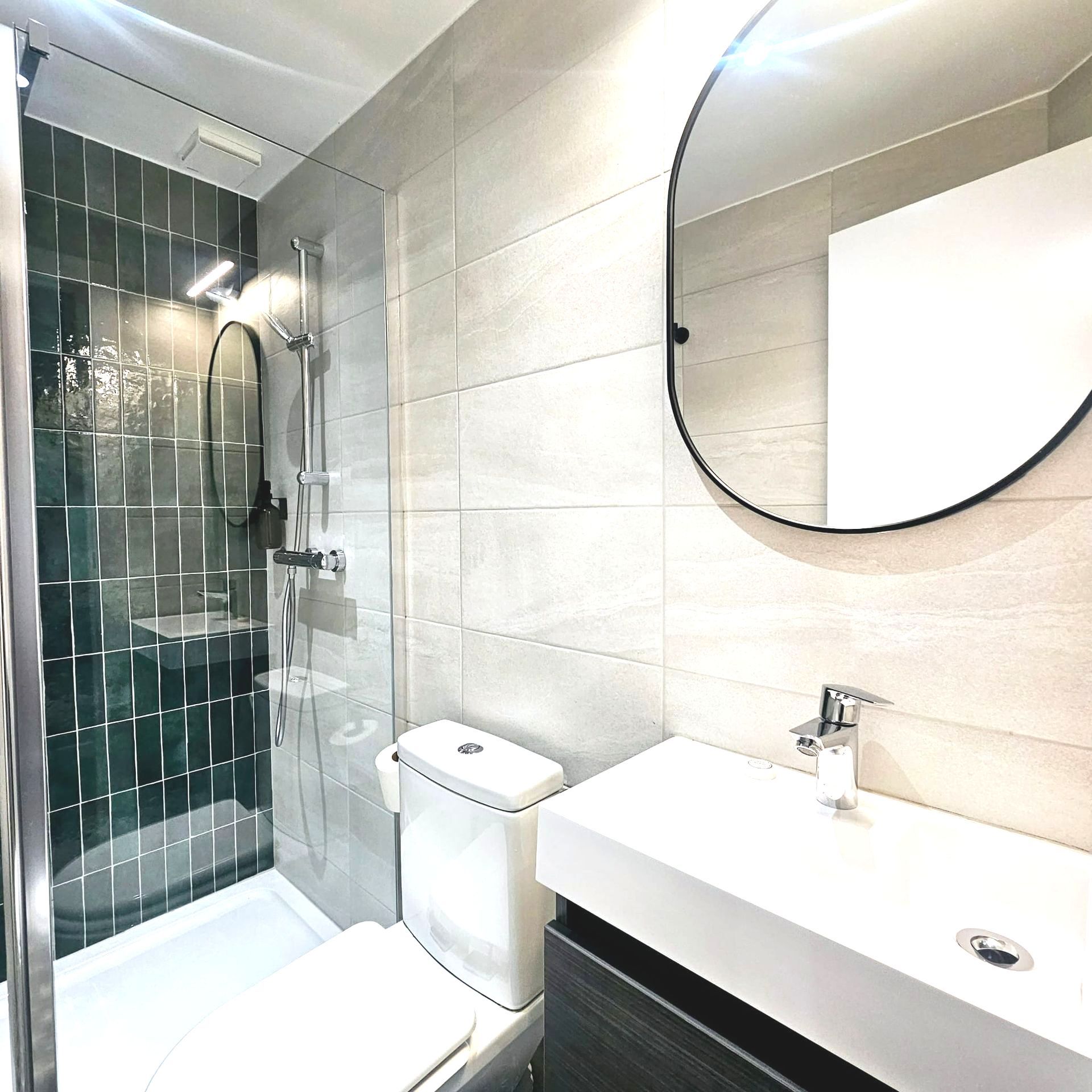 A bathroom with a toilet a sink and a mirror