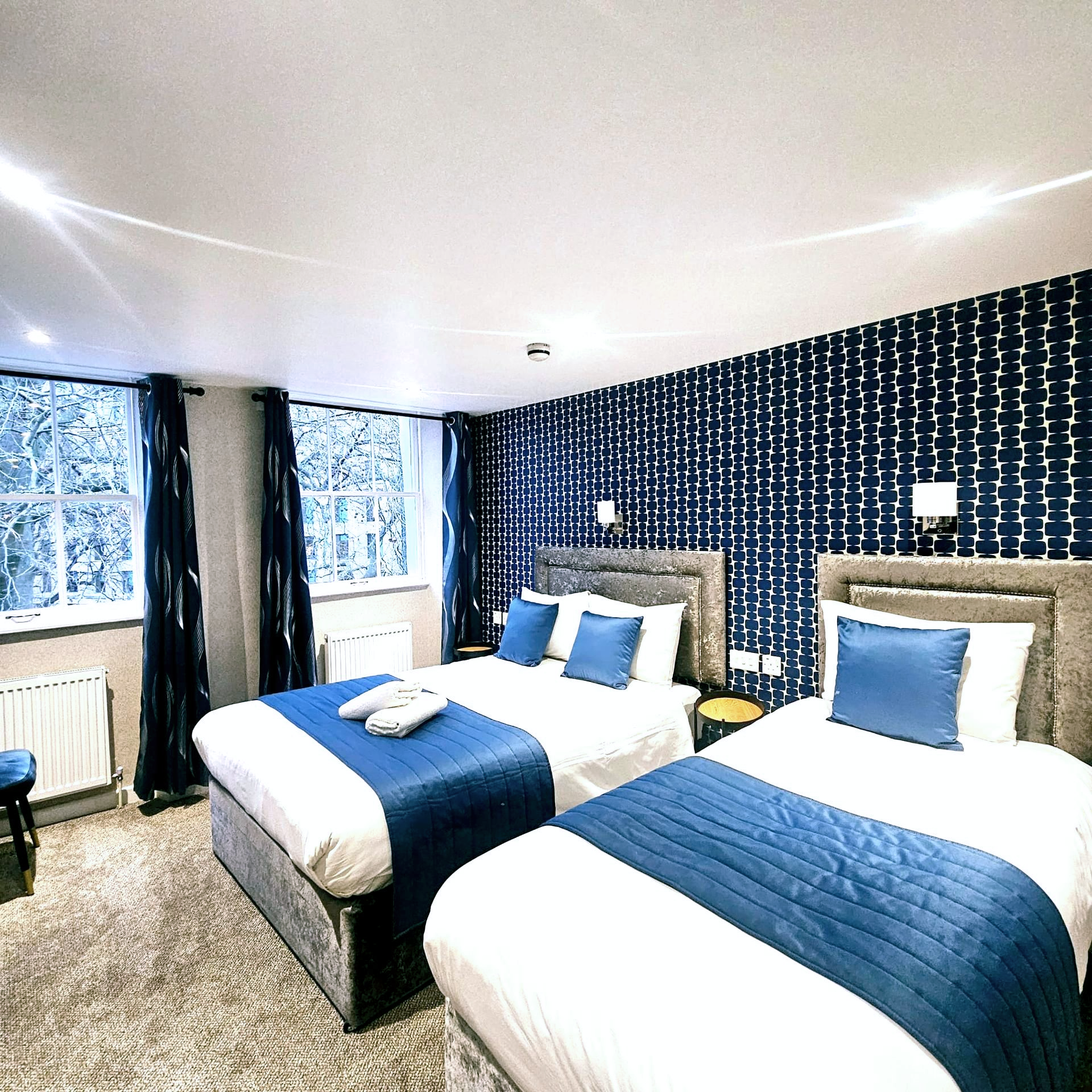 A hotel room with two beds and a window