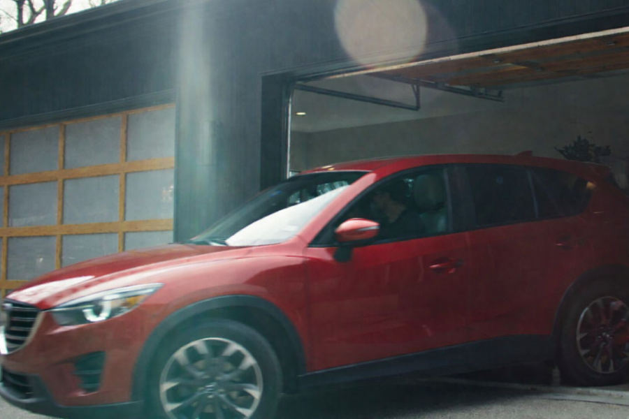 Red SUV parked in a garage with the driver door open