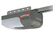 Gray garage door opener motor mounted on a ceiling track with red logo and light gray cover
