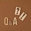 Q&A with question mark and exclamation mark tiles on a brown background