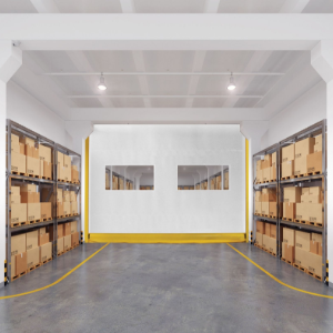 Bright warehouse aisle with stacked boxes on shelves and a white wall at the end