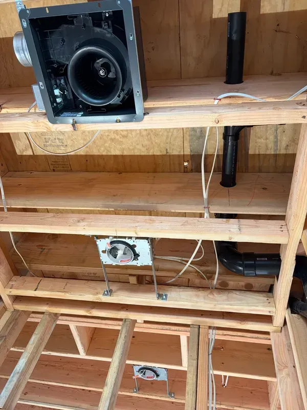 Exposed wooden ceiling with speaker and electrical wiring in an unfinished room