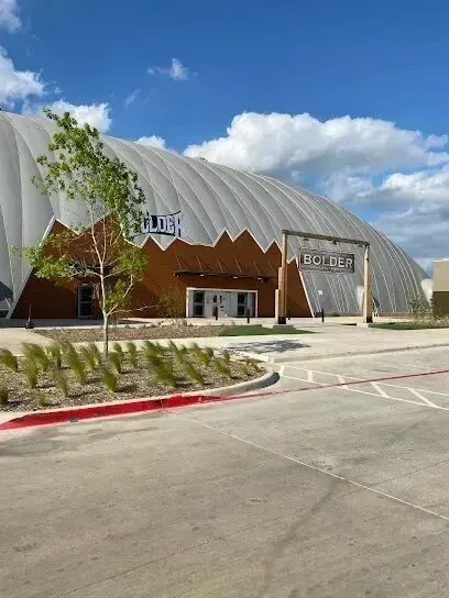 Burleson Electrician - Large, white, arched fabric structure with 
