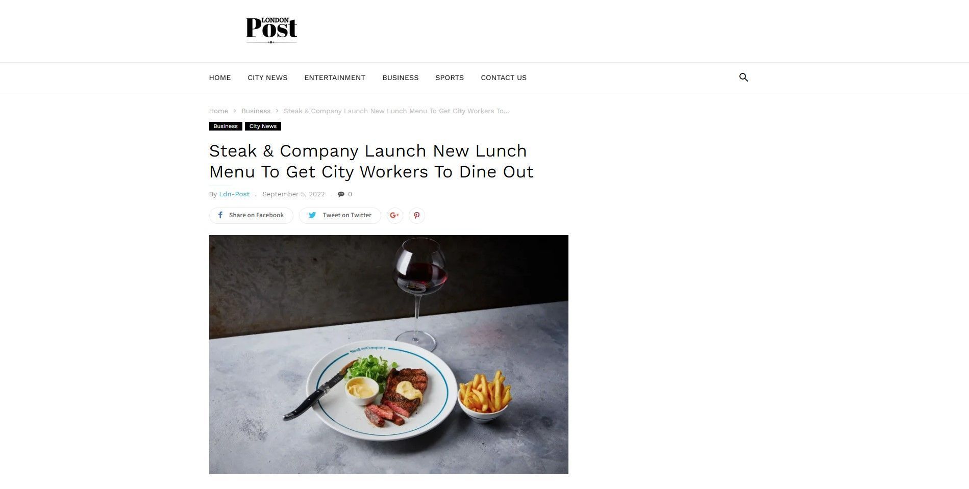 Steak & Company lunch menu. Steak, fries, and wine on a plate in front of an article about a lunch menu.