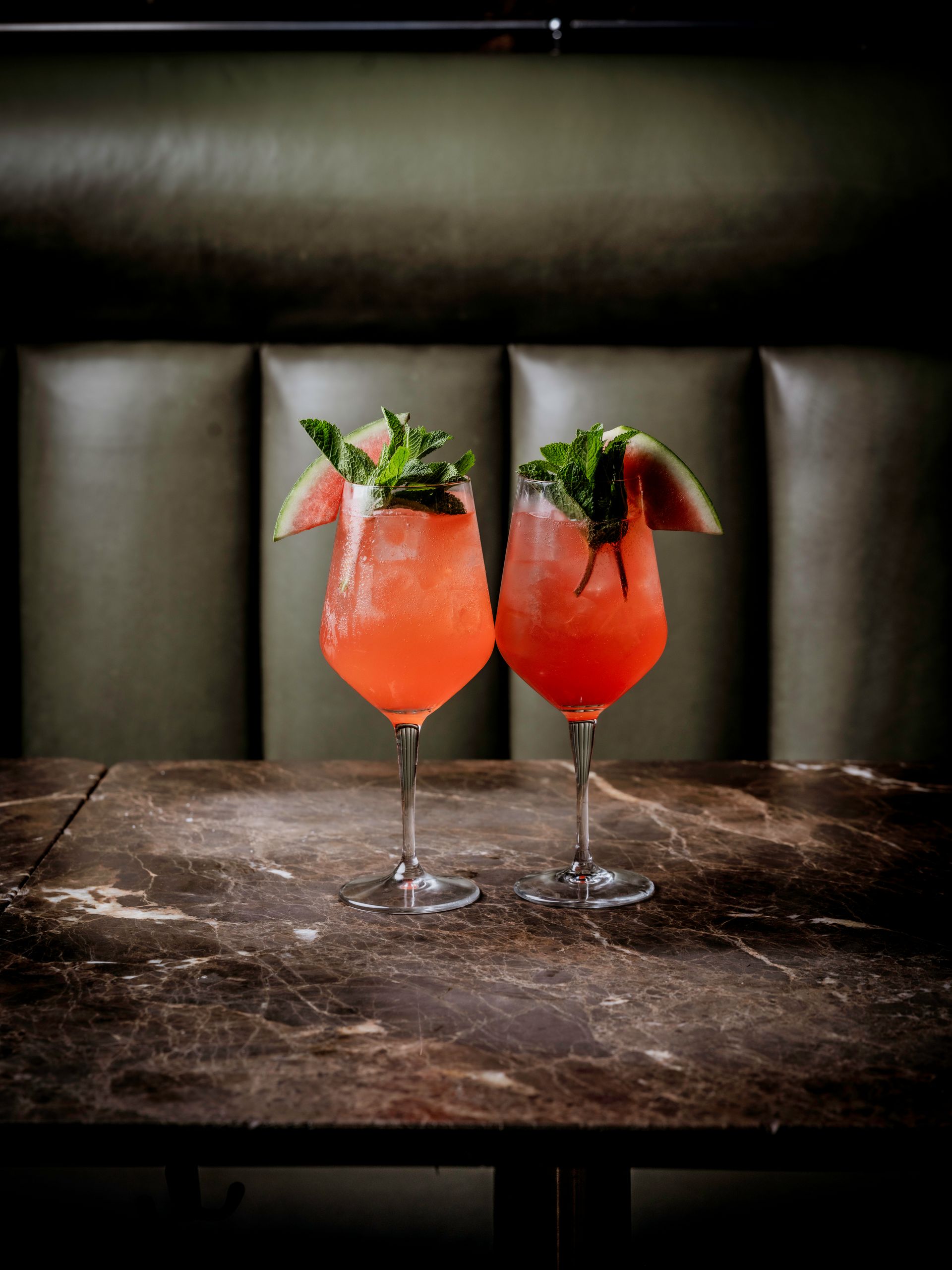 Two short cocktails to Begin & End a meal on a light marble table.