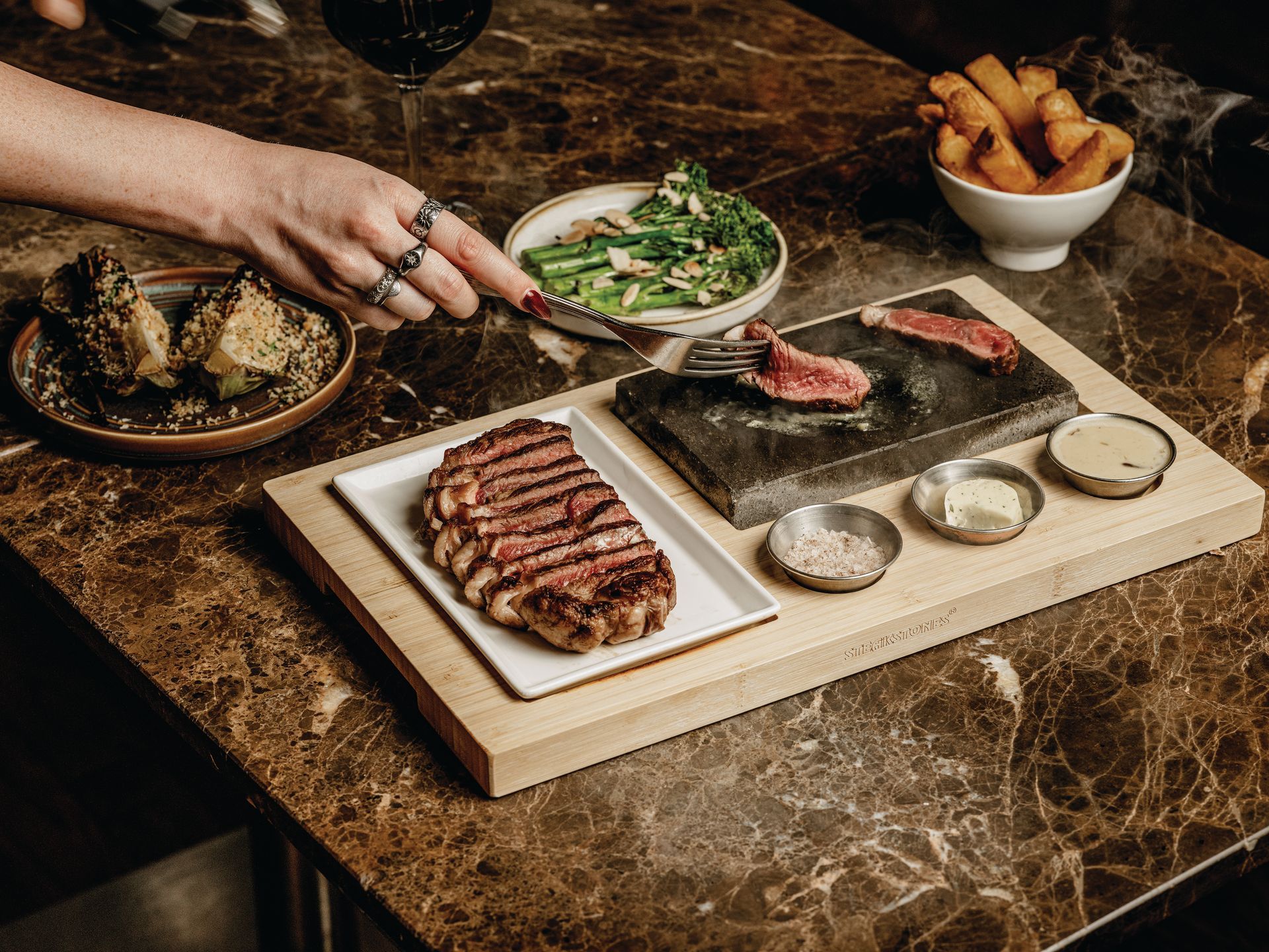 Halal sliced steak with a Hot Stone, peppercorn sauce,  butter and salt, with a green salad, baked Sweet Potato and Heritage Tomatos.