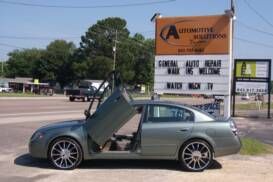 Vehicle at Automotive Solutions with door open after brake service