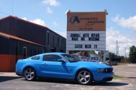 Car in front of Automotive Solutions sign in Charleston, SC