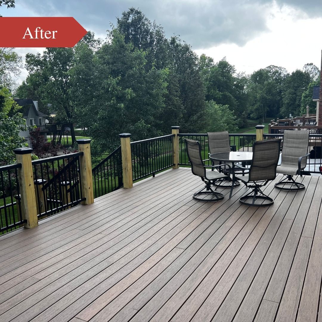 Spacious wood deck with metal patio chairs, railing, and trees beyond under cloudy sky