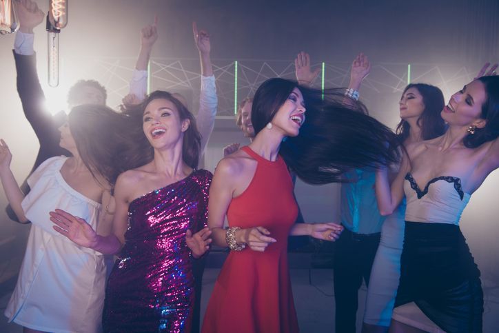 A group of women are dancing together at a party.
