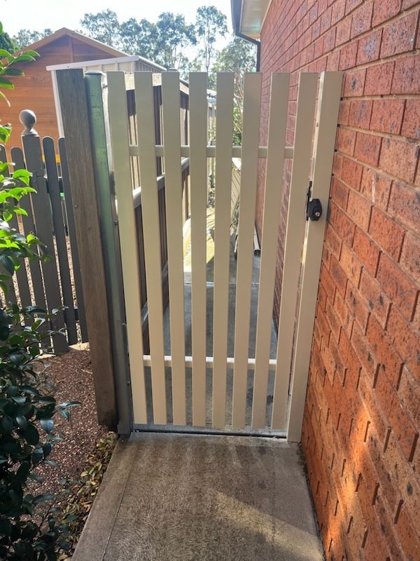 A White Fence with a Lock on it — Newcastle & MidCoast Privacy Screens and Gates In Kurri Kurri, NSW