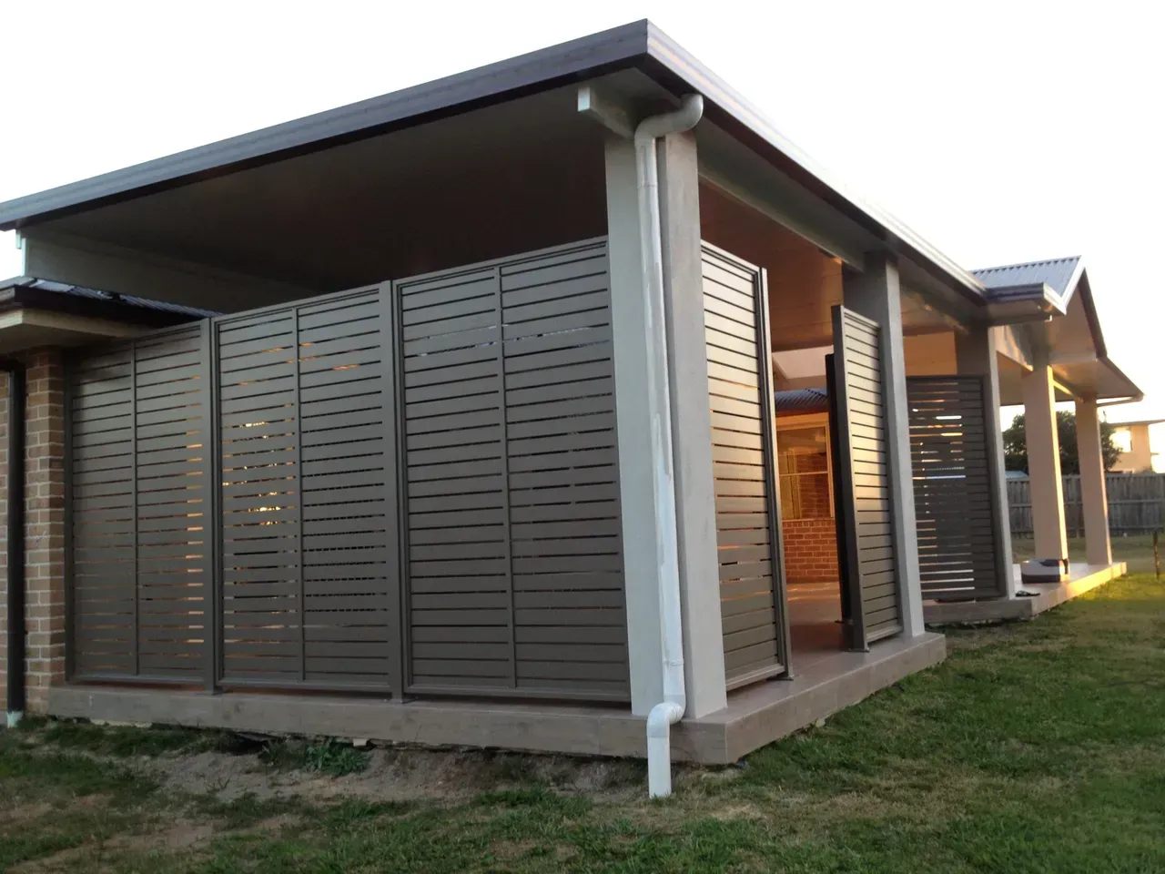 A House With a Lot of Shutters on the Side of It — Newcastle & MidCoast Privacy Screens and Gates, NSW