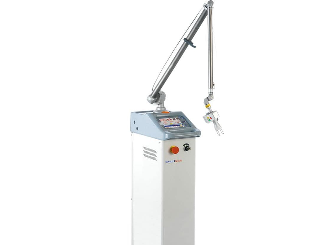 Industrial machine with angled robotic arm and control panel on a white background