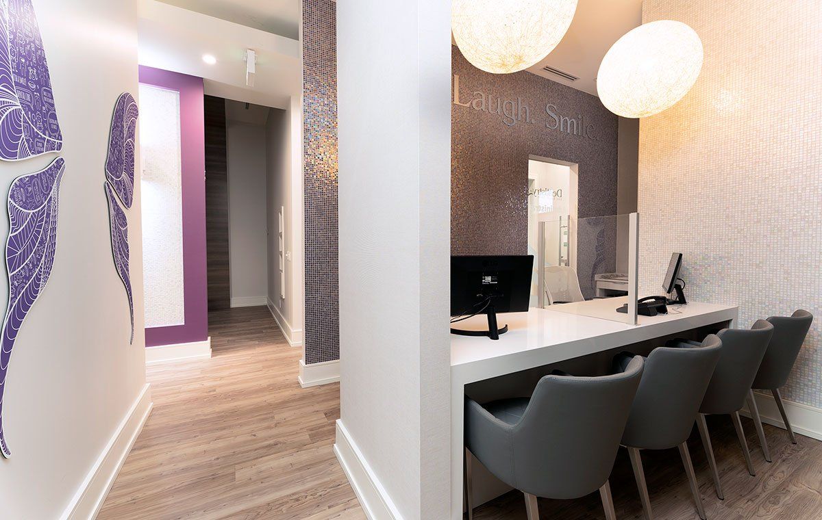 Modern salon interior with white styling chairs, mirrors, and gray pendant lights