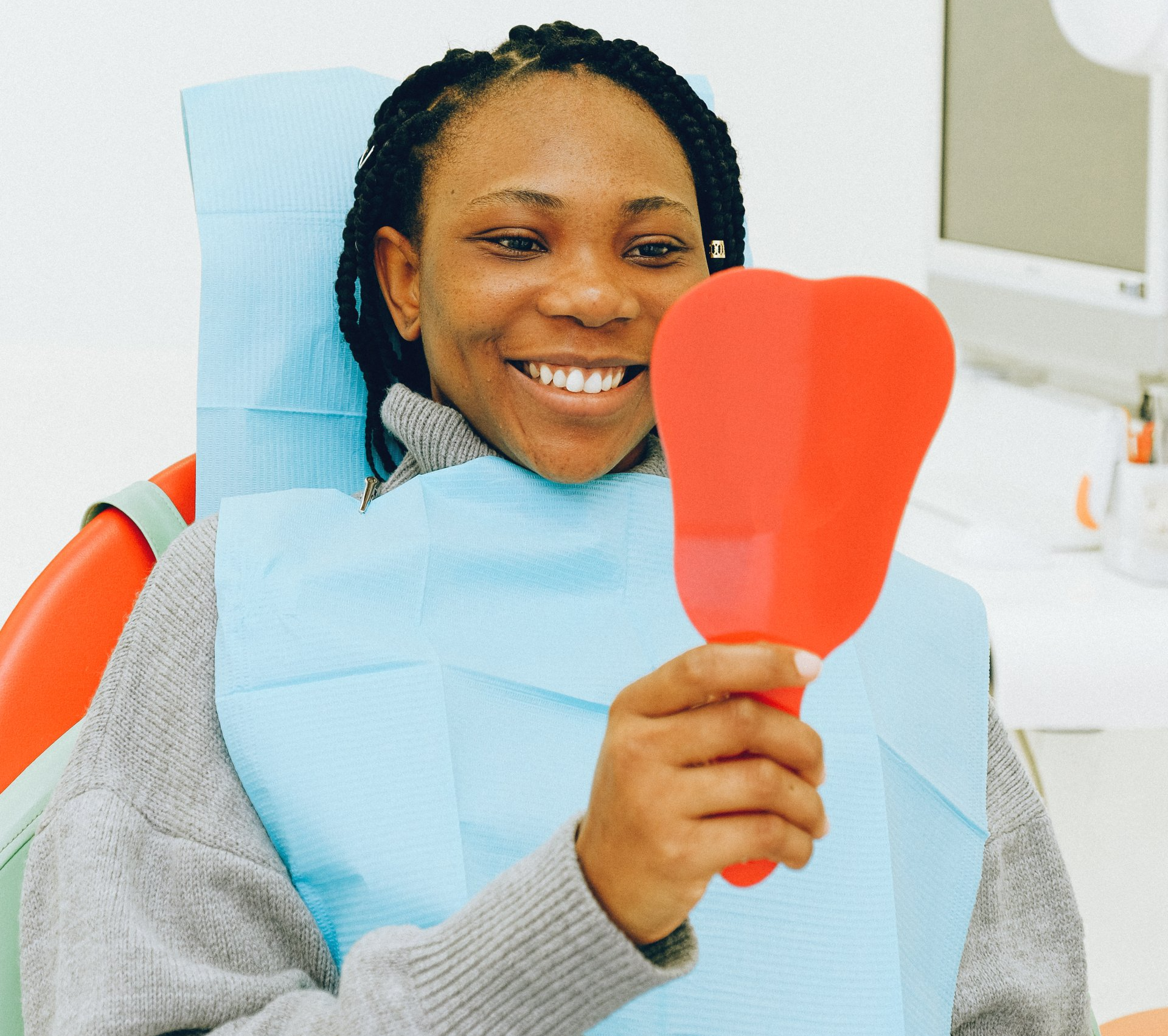 Patient inspecting teeth with mirror