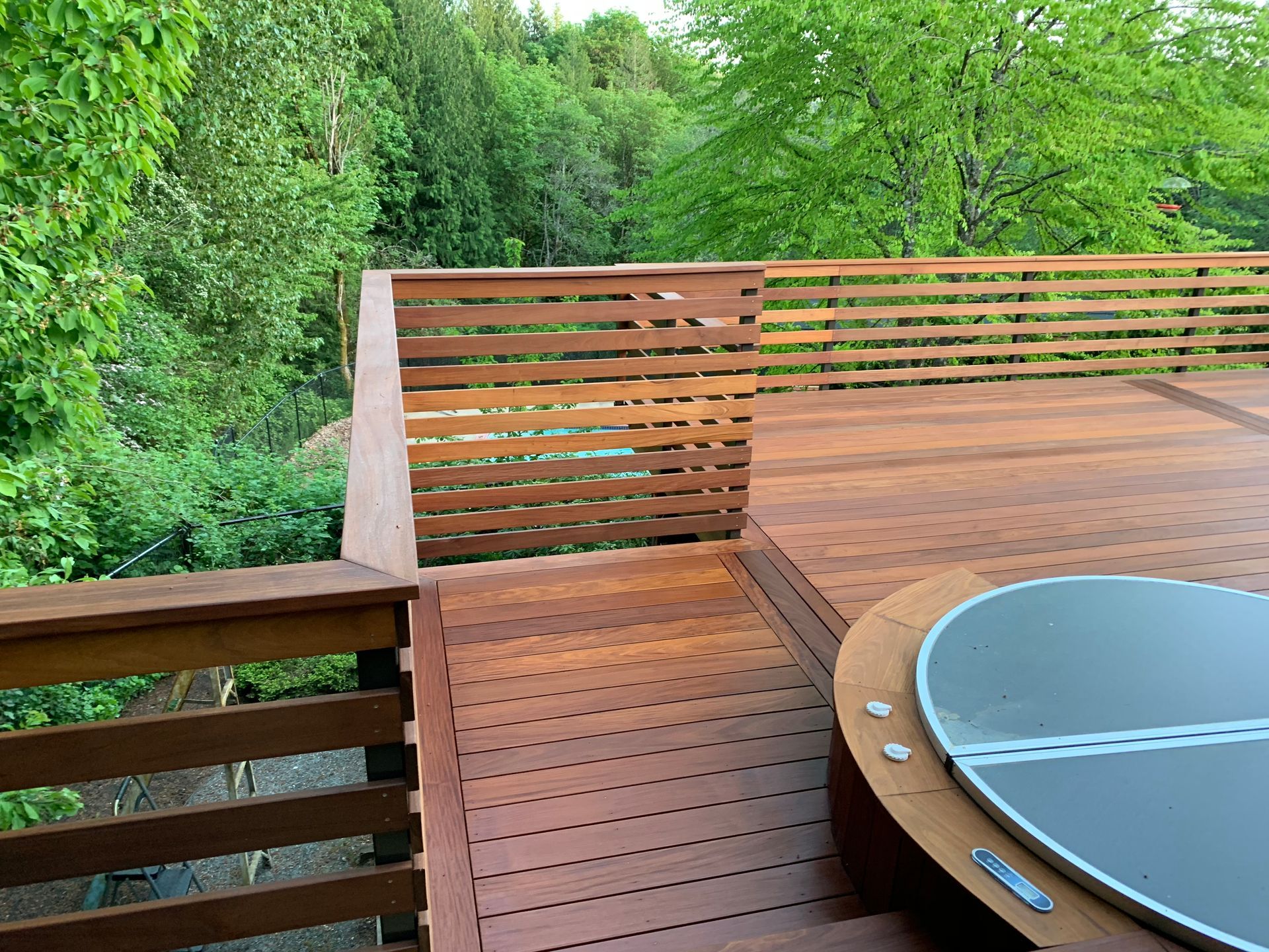 A wooden deck with a hot tub on it