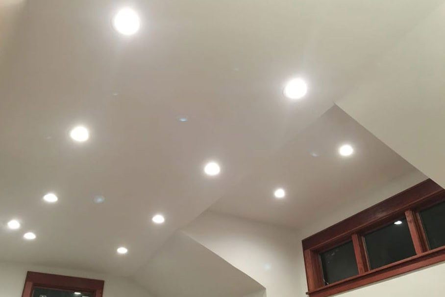 A ceiling with a lot of lights on it and a window.