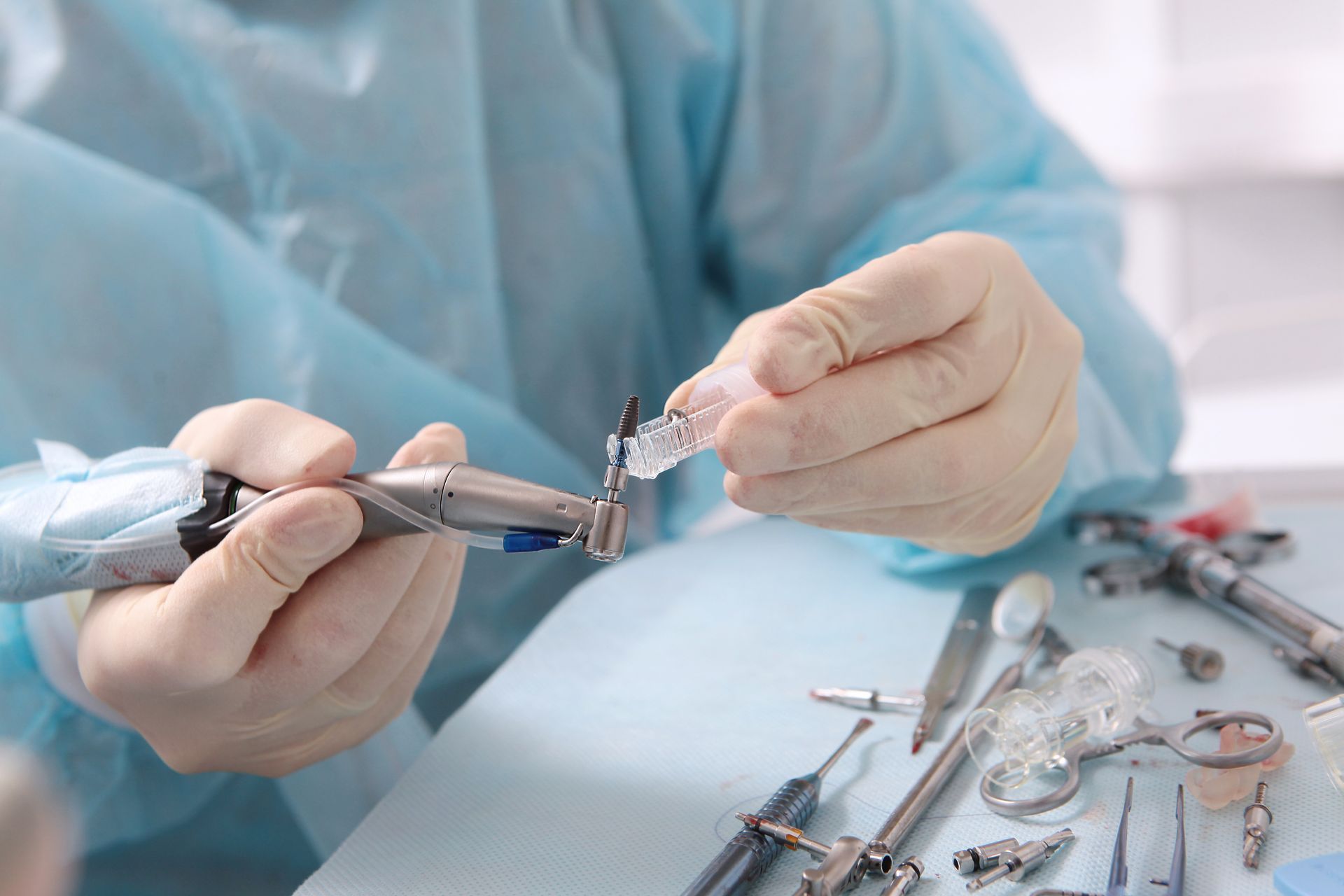 A dentist is holding a dental implant.