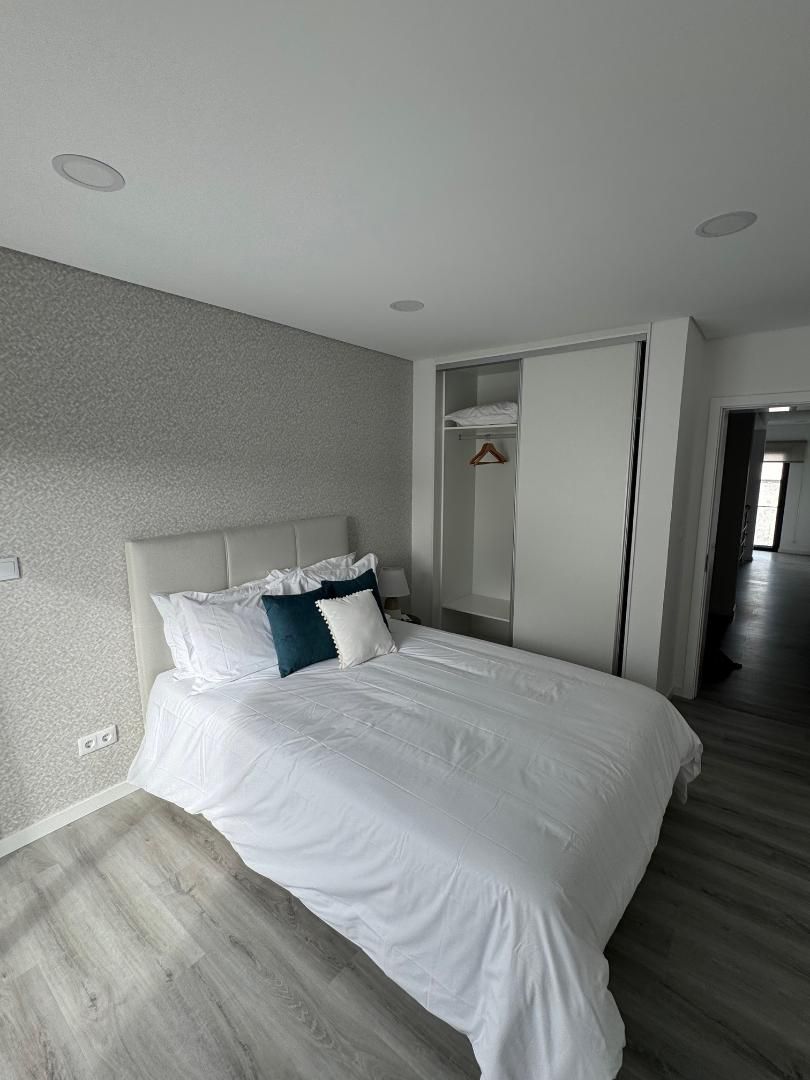 A bedroom with a large bed and a closet.