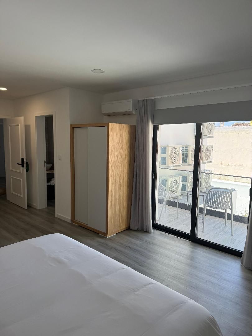 Wardrobe closet and furnished balcony