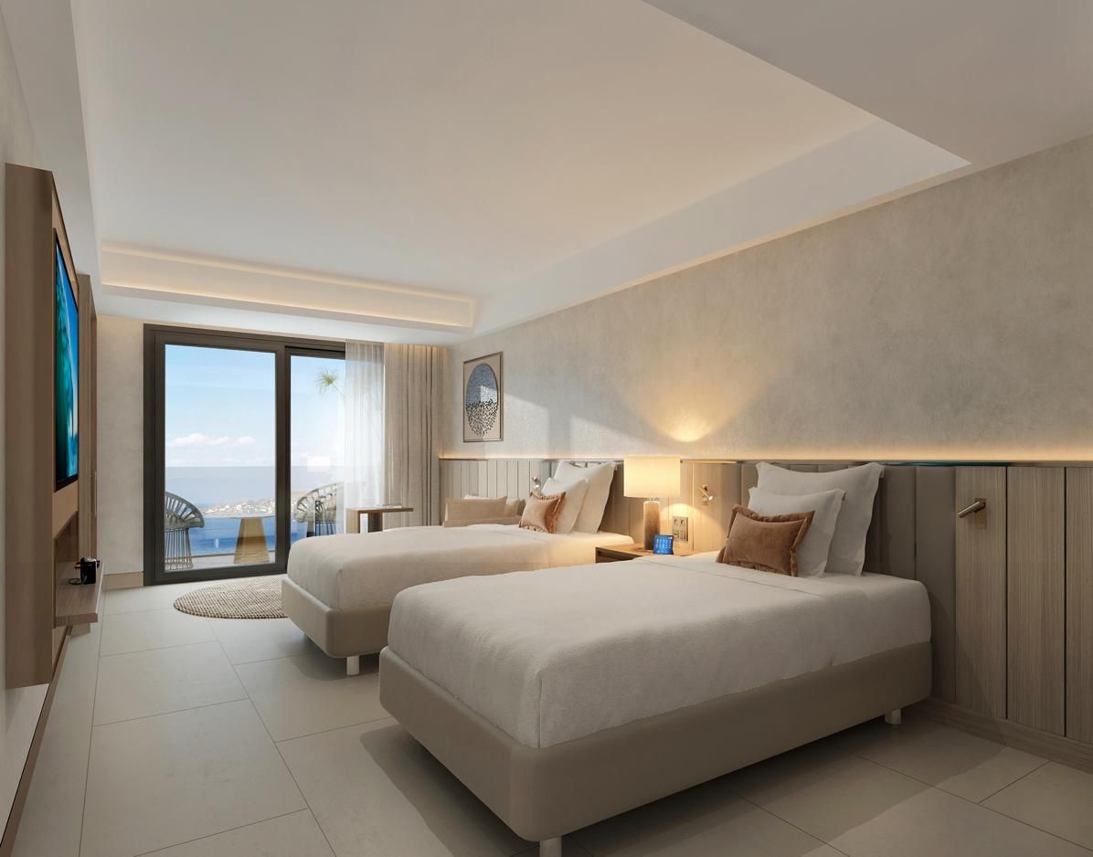 A modern, neutral-toned hotel room featuring two twin beds, ambient wall lighting, and a balcony with a sea view.
