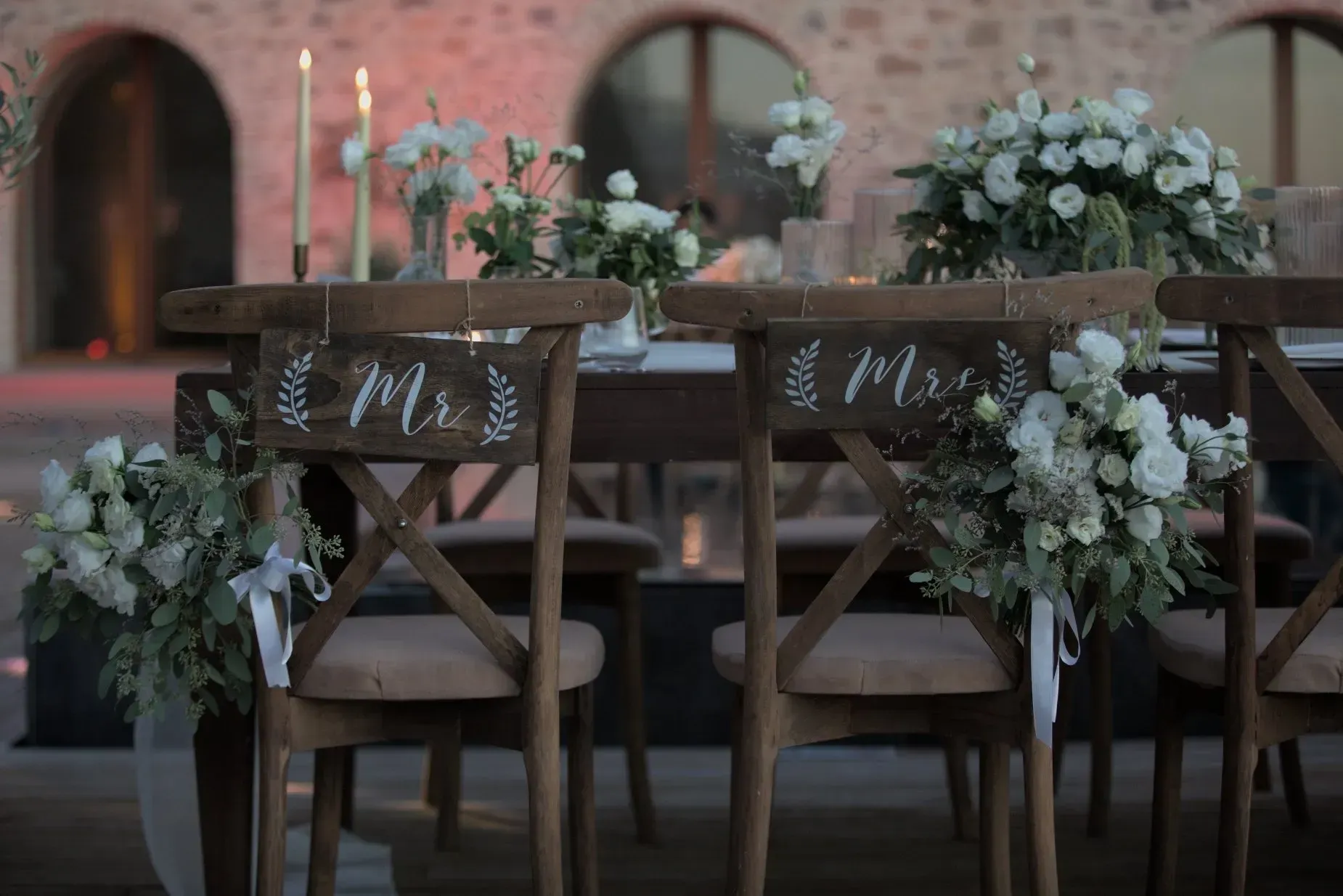 Two wooden wedding chairs marked 