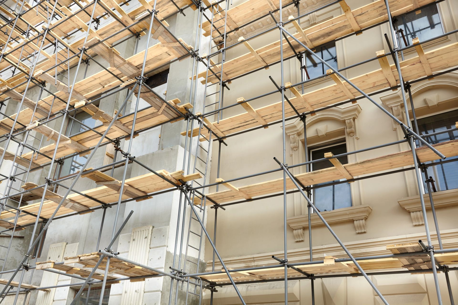 Facciata dell'edificio coperta da impalcature durante i lavori di ristrutturazione esterna.