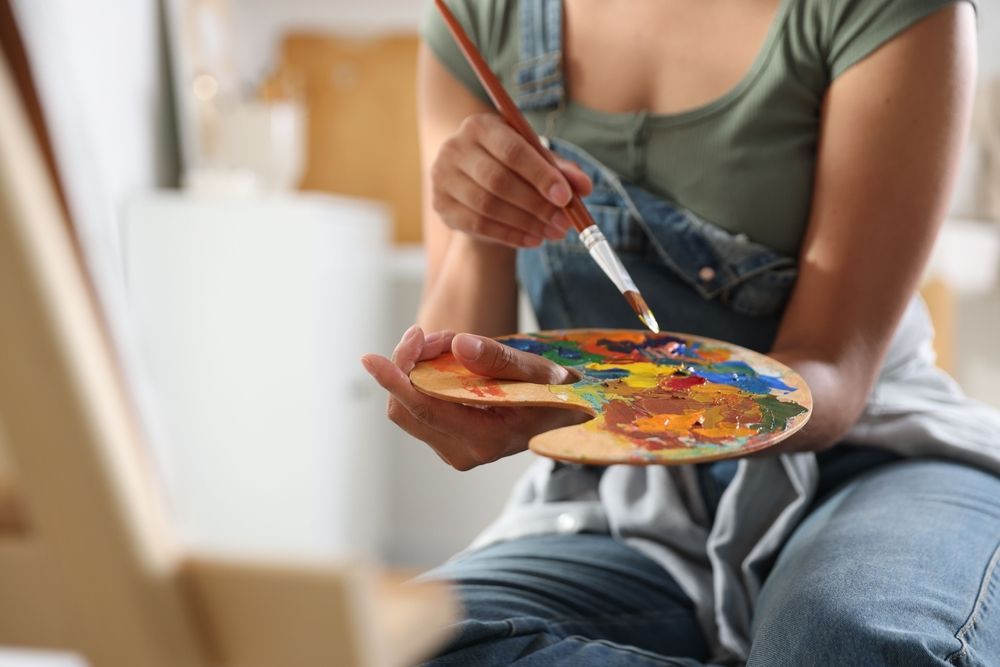 A painting of a rainbow colored circle on a white background