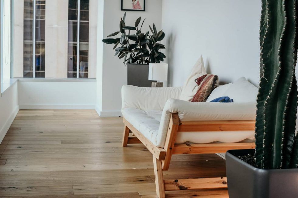 Living Room With Wooden Sofa And Vinyl Flooring — Cairns Floors and More In Bungalow, QLD