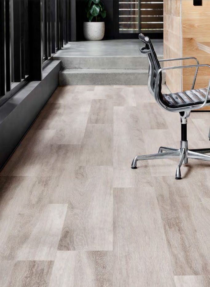 Wooden Flooring With A Black Chair On It — Cairns Floors and More In Bungalow, QLD