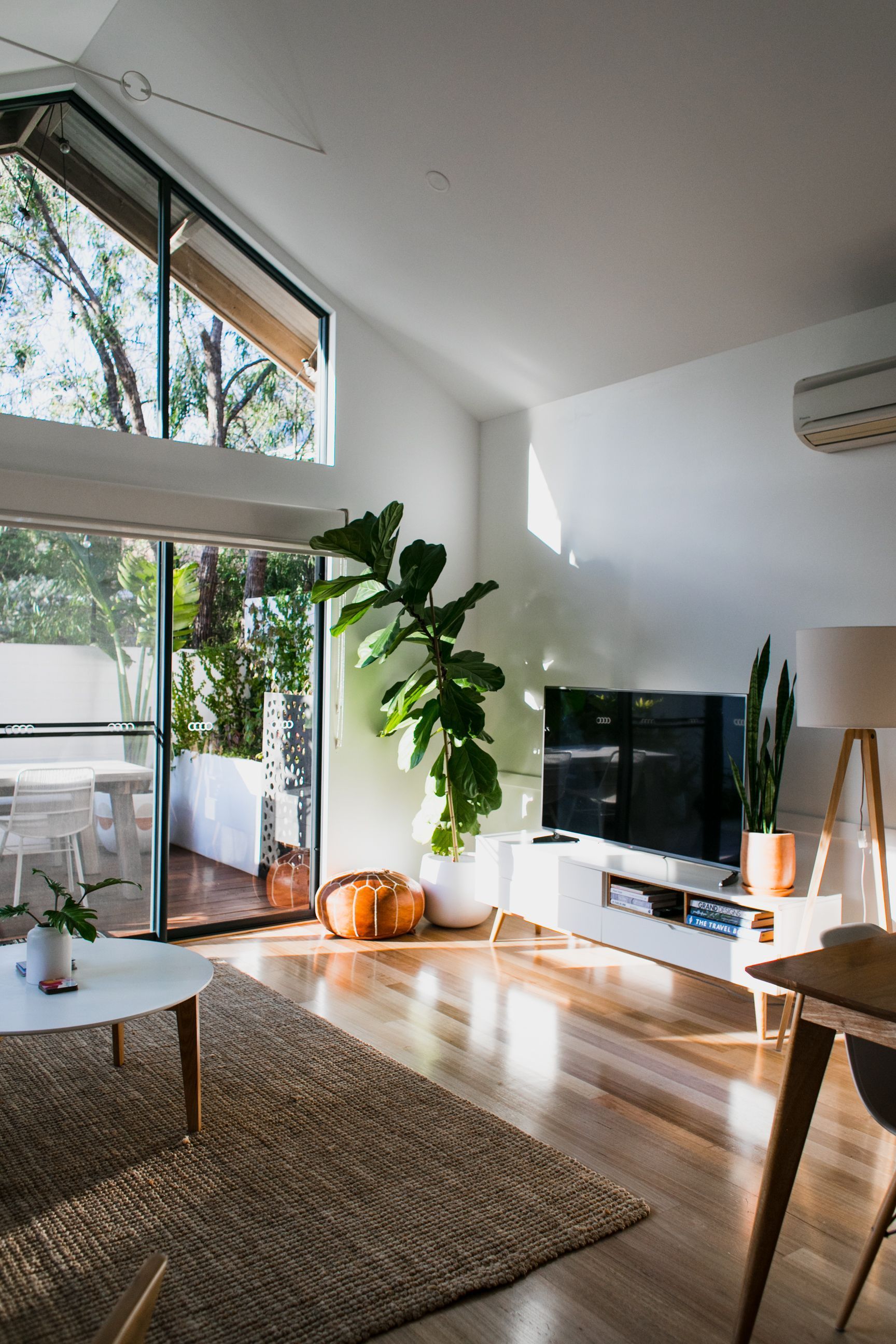 A Living Room With a Couch, Table, Lamp and Wooden Floor — Cairns Floors and More In Redlynch, QLD