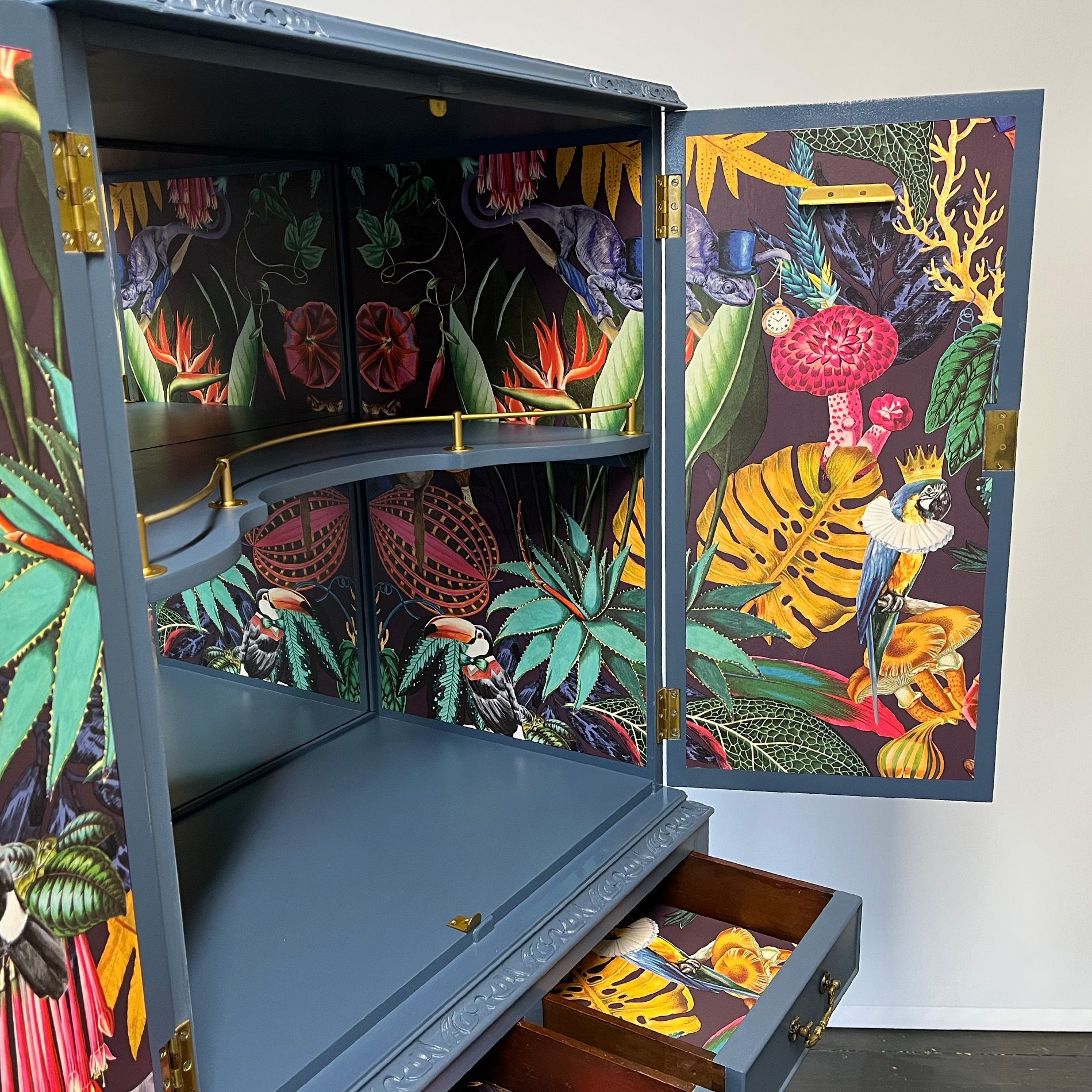 Decoupage detail panels inside blue upcycled cocktail cabinet