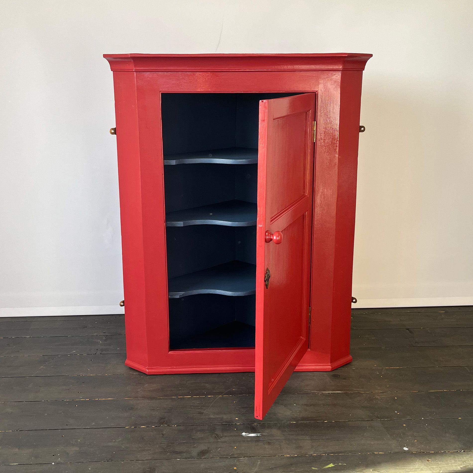 Red wall cabinet with paynes grey interior. Upcycled by Helen Bateman