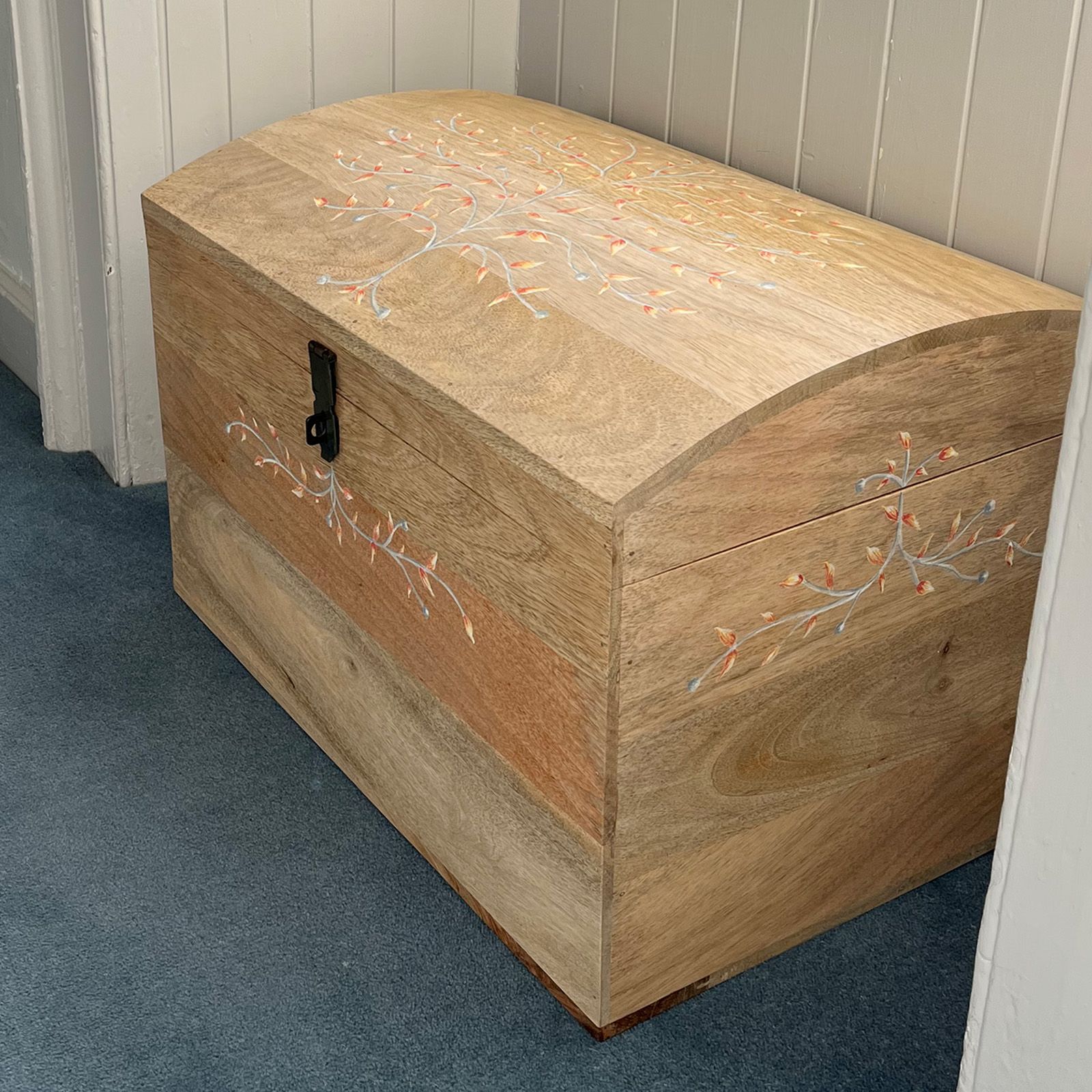 Mini wedding chest tucked under a window alcove.