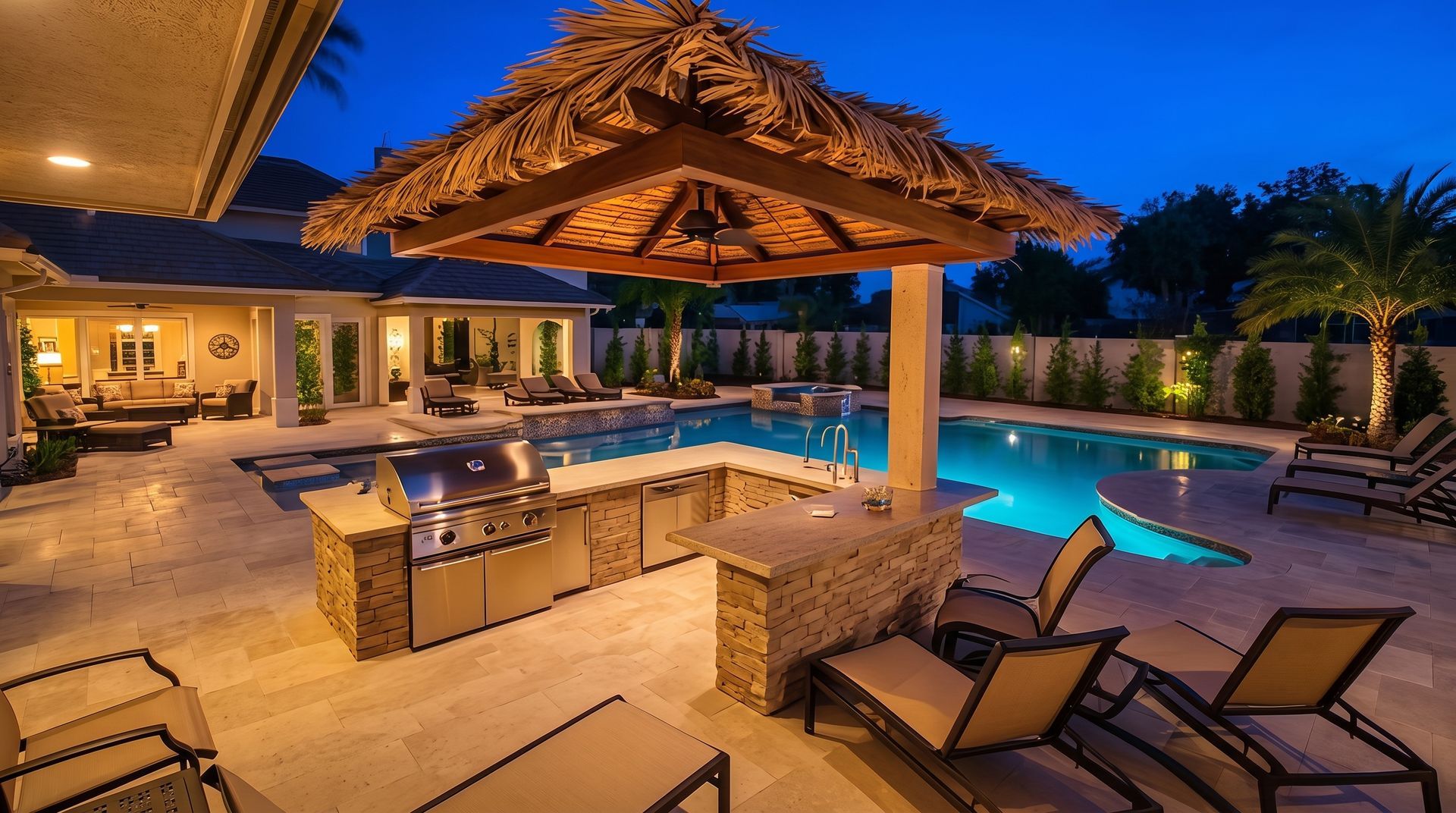 Tropical backyard pool at dusk with tiki-style bar, patio seating, and glowing blue water