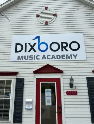 A white building with a sign that reads 