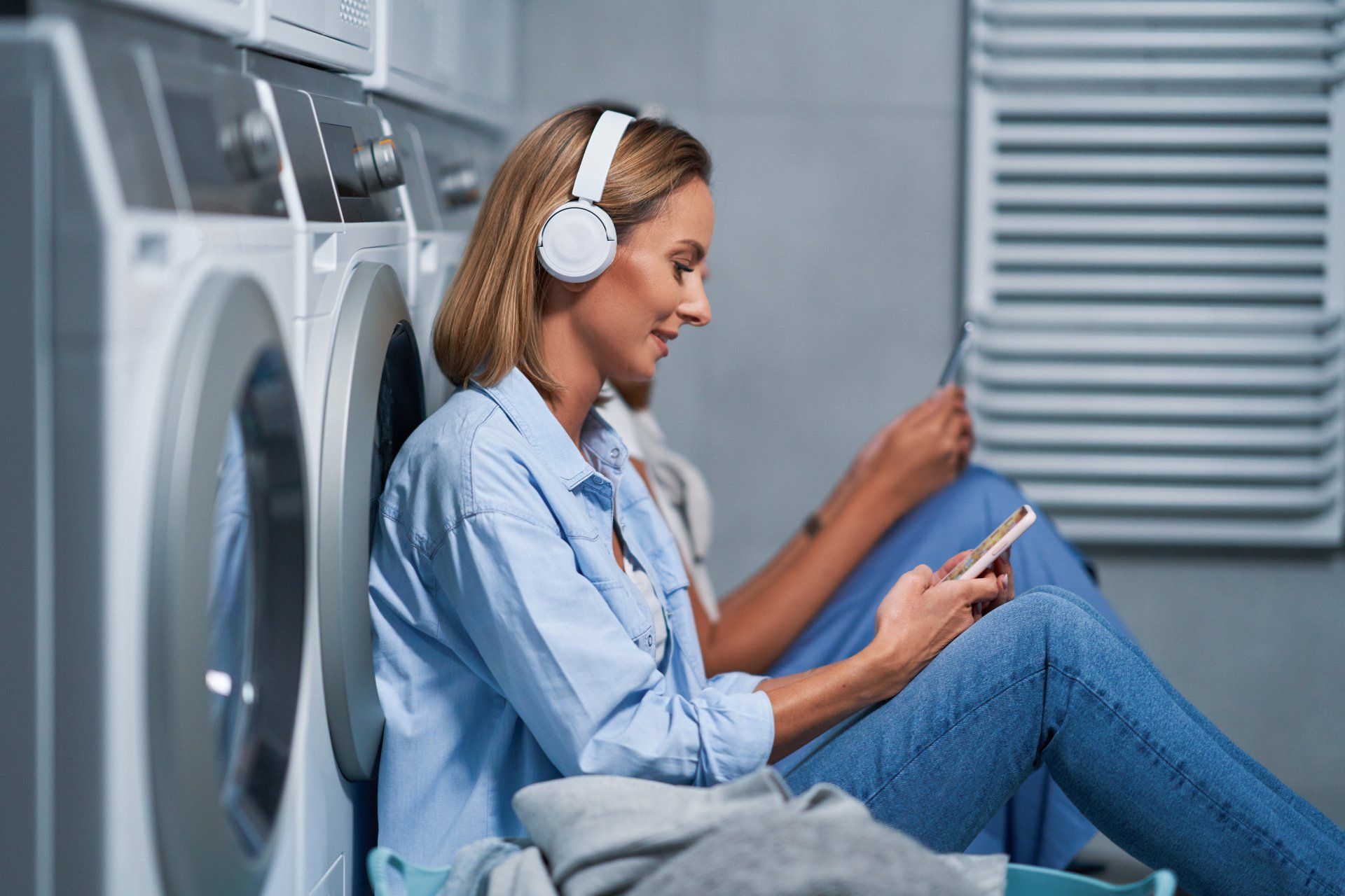 Woman reading in laundry room