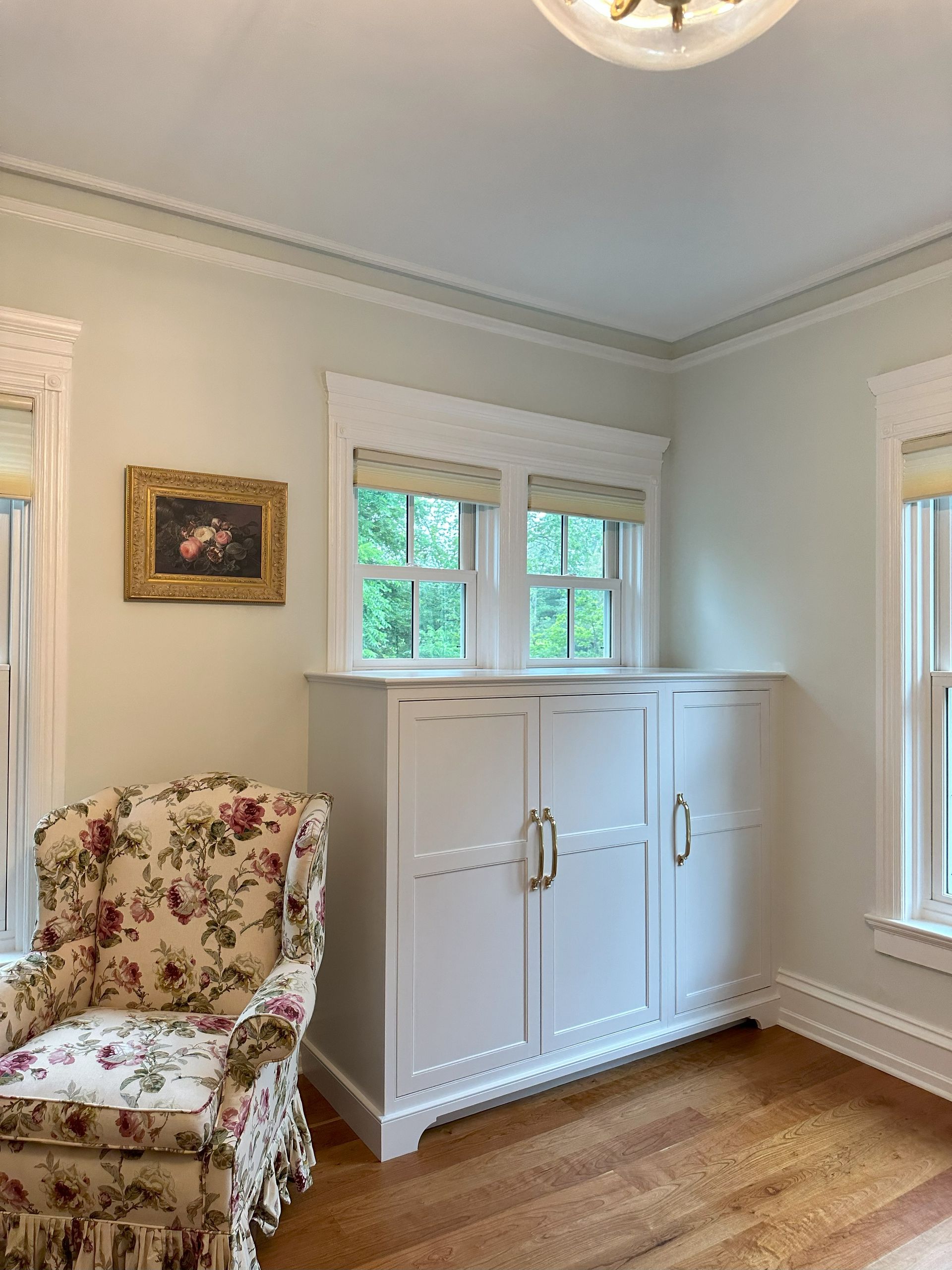 There is a chair and a cabinet in the room.