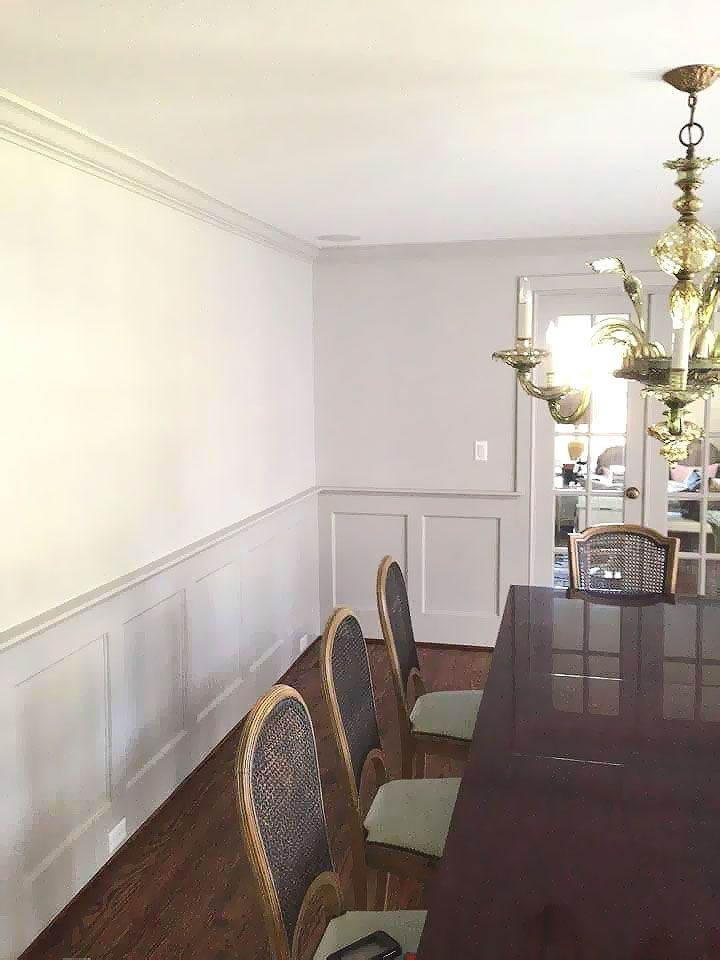 A dining room with a table and chairs and a chandelier