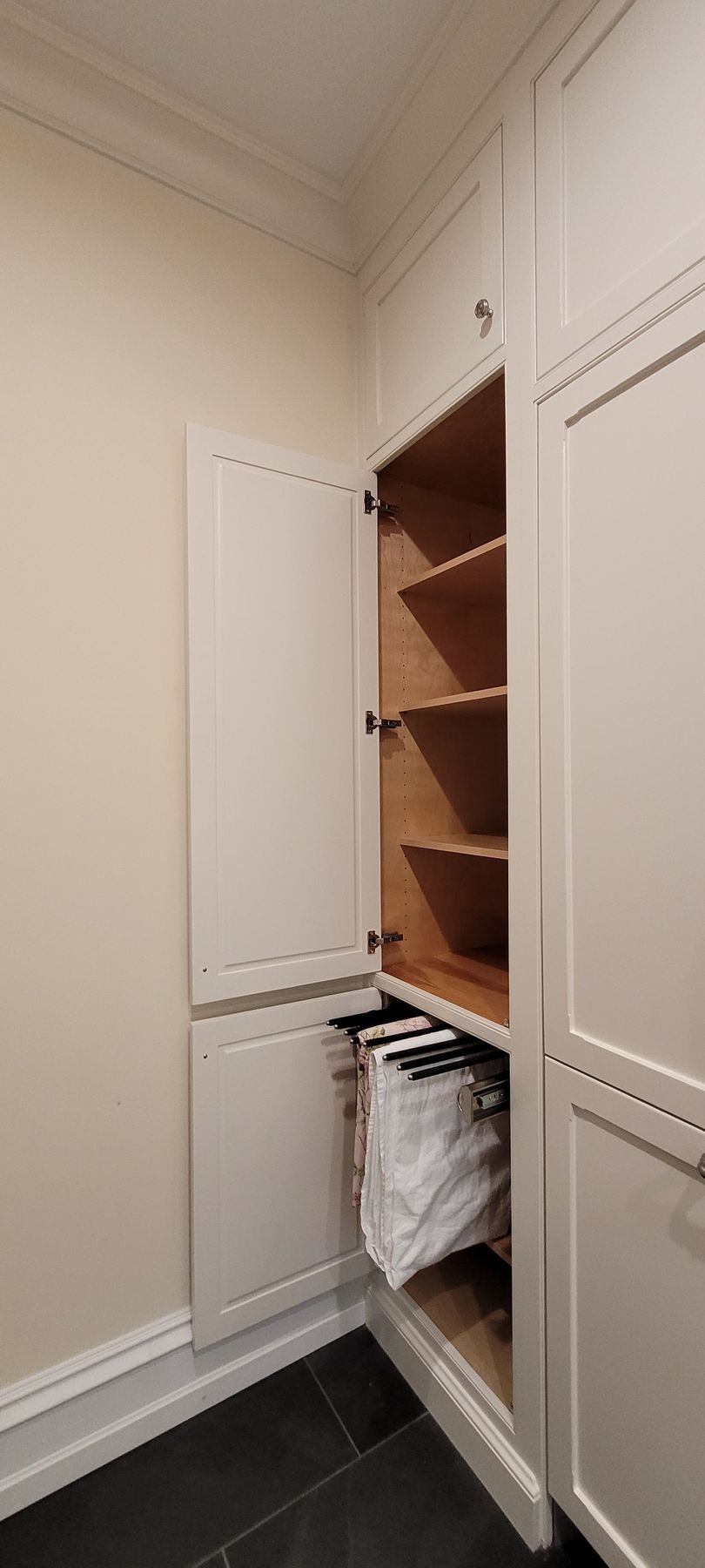 A kitchen with a refrigerator built into the wall.
