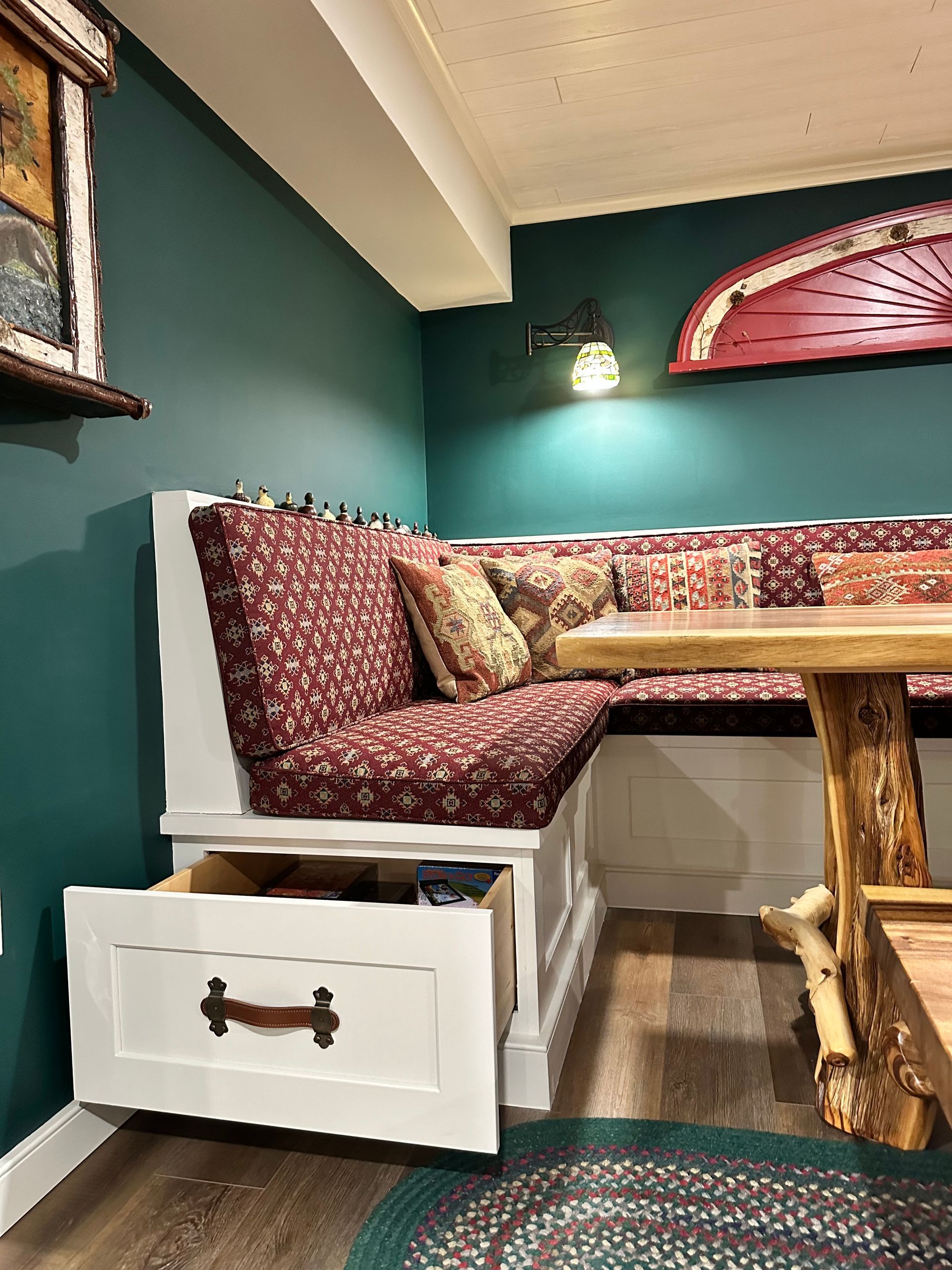 A room with a couch and a table with a drawer underneath it