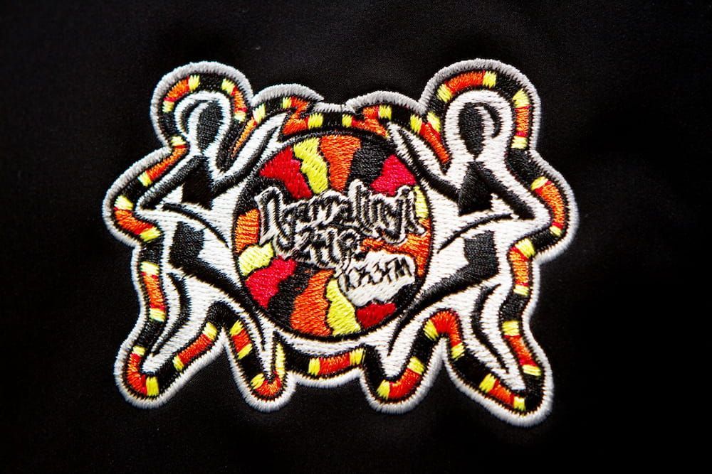 Embroidered Patch Surrounded by Abstract Colorful Design — Workwise Clothing Forster in Forster, NSW
